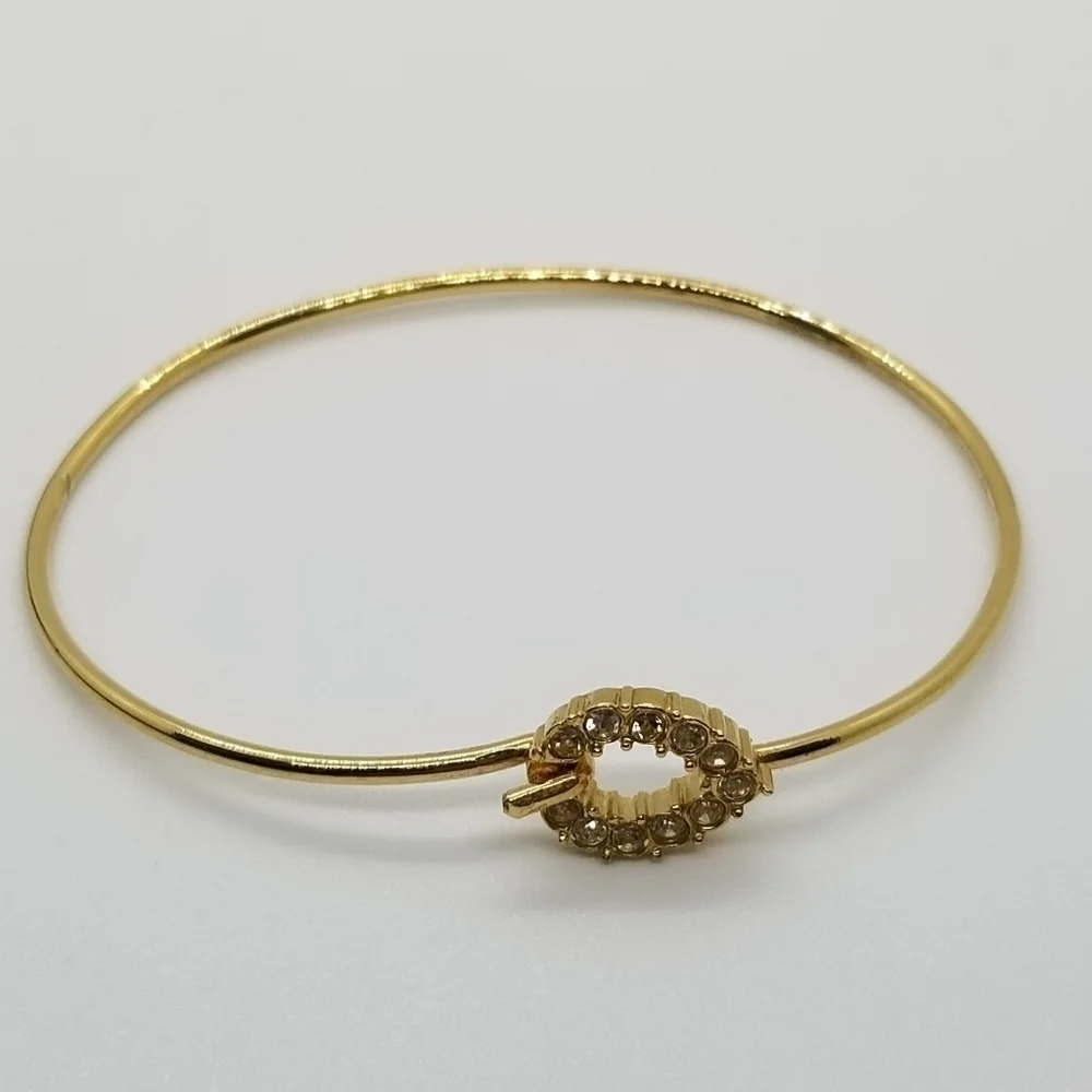 gold tone bracelet with pave rhinestone teardrop clasp